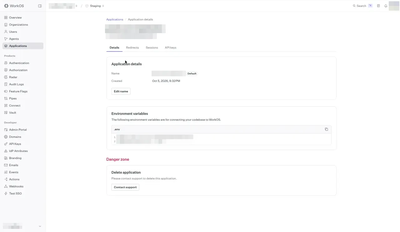 The Application details page on the Details tab. The application name and Client ID chip under the title are blurred, as are the two lines in the .env box under Environment variables. A Danger zone section at the bottom has Delete application.