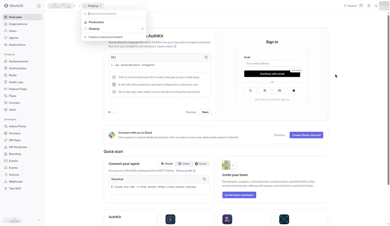 The WorkOS Overview page with the environment switcher open next to the project name, which is blurred. Your project name appears there. The list shows a Search environments box, Production, Staging with a check mark, and Create a new environment.