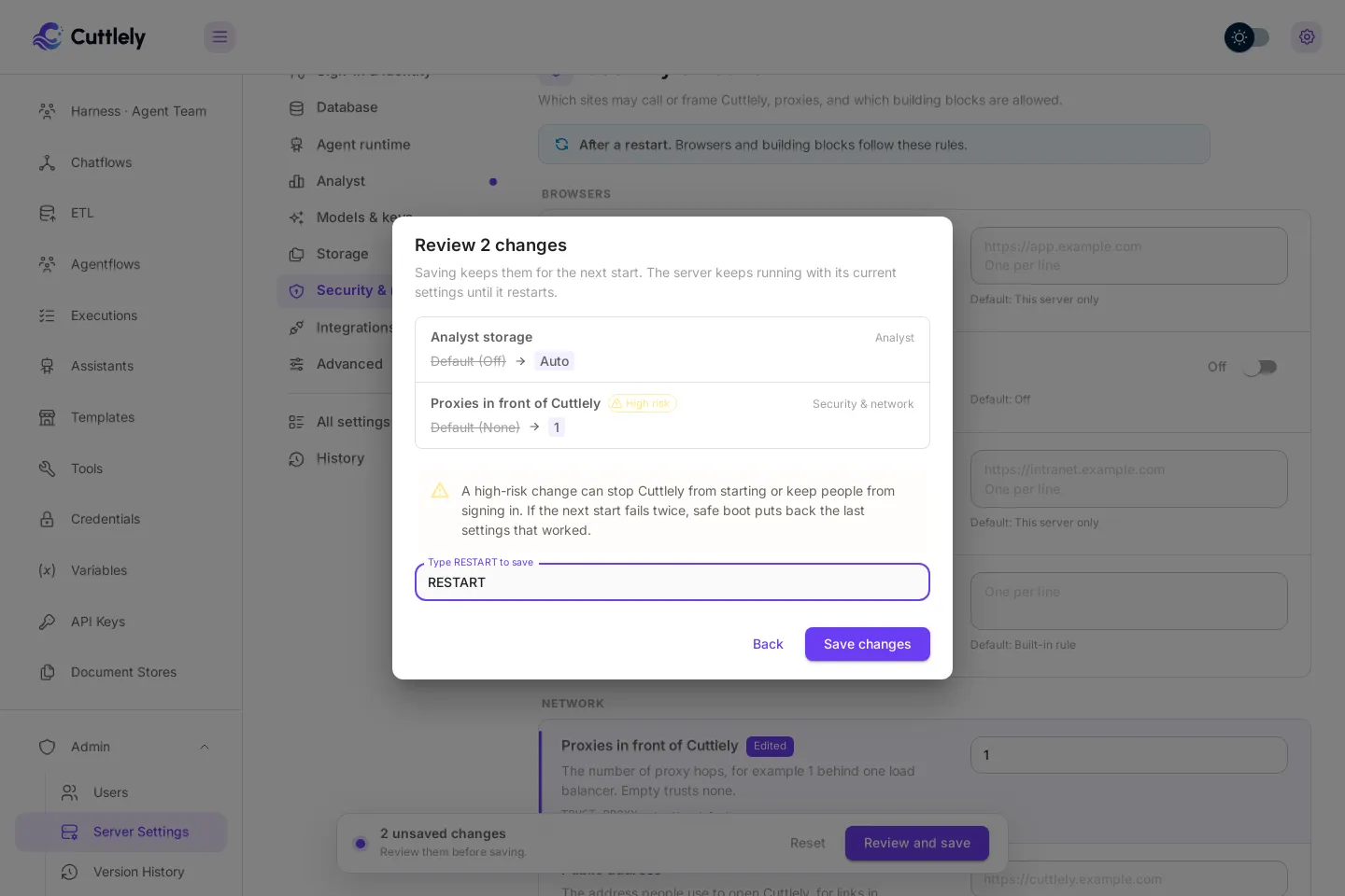 A high-risk change: the Review 2 changes dialog warns that the change can stop people from signing in, and RESTART is typed in the box before Save changes.