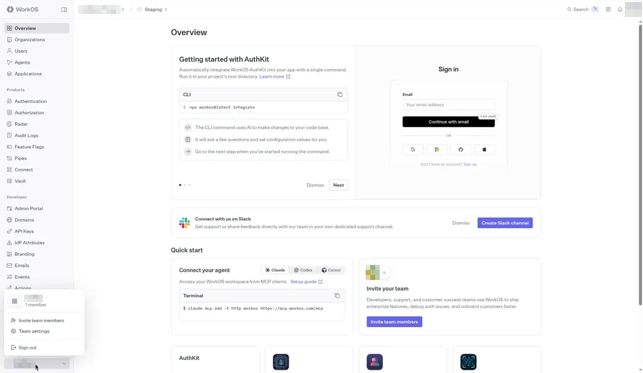 The WorkOS dashboard with the team switcher open at the bottom of the left sidebar. It shows the team, with its name and initial blurred, and 1 member, then Invite team members, Team settings, and Sign out. Your team name appears here and at the bottom of the sidebar.